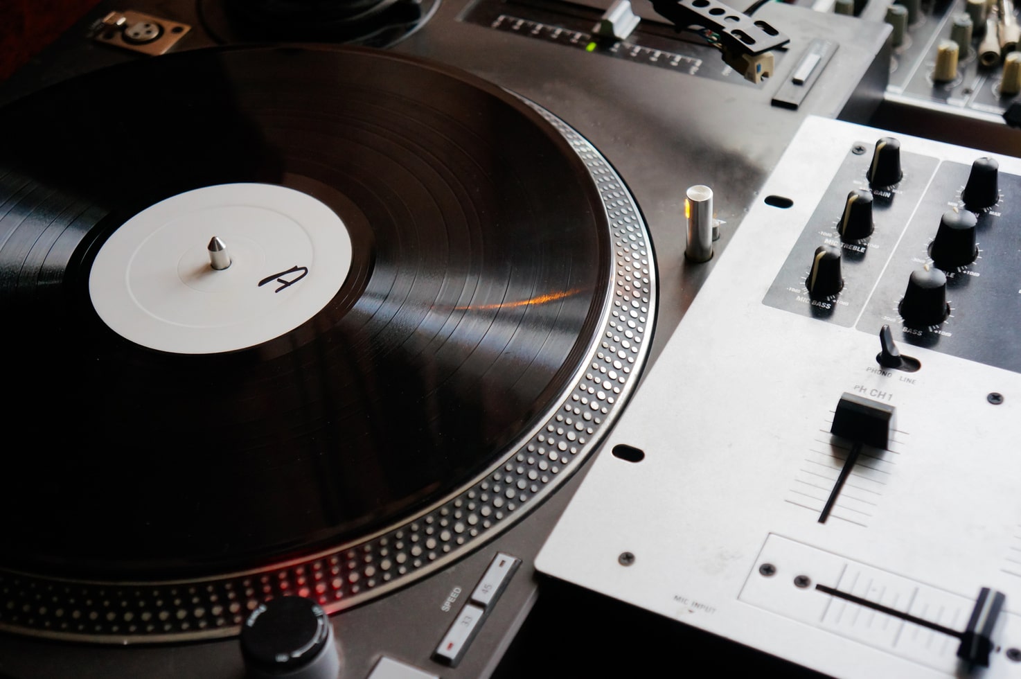 A vinyl player next to a sound system.